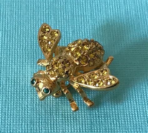 Round, faceted crystals on the upper body create sparkle and shine, while round, green crystal eyes are mystifying. . Joan rivers bee pin